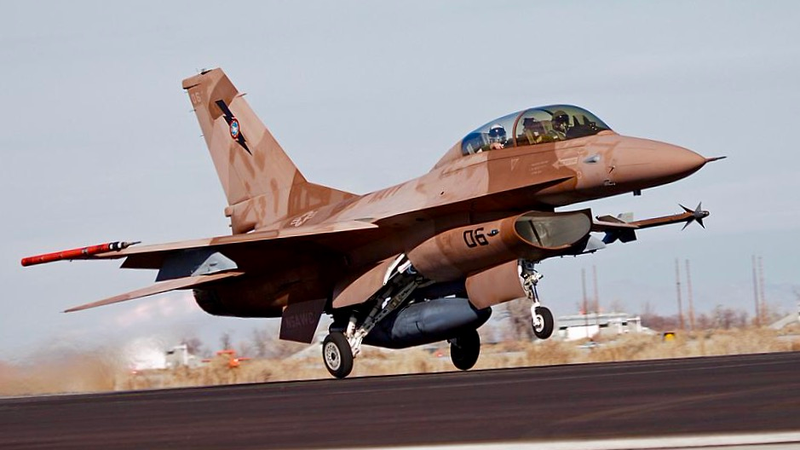 Note the tiny front wheel, main wheels cambered out, and the external fuel tanks sharp angle up in the rear to alleviate tail strikes.